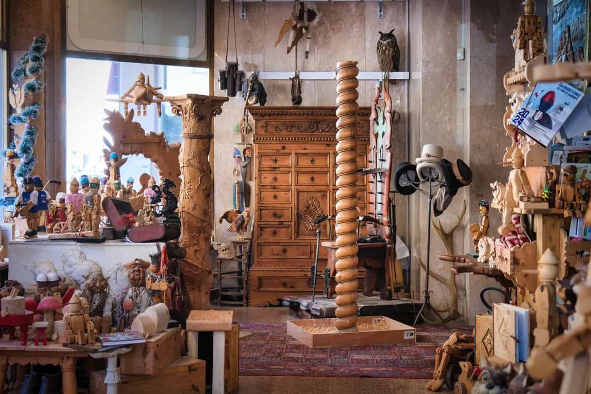 A wood-carver’s atelier in the Dolomites, filled with hand-carved figures and furniture