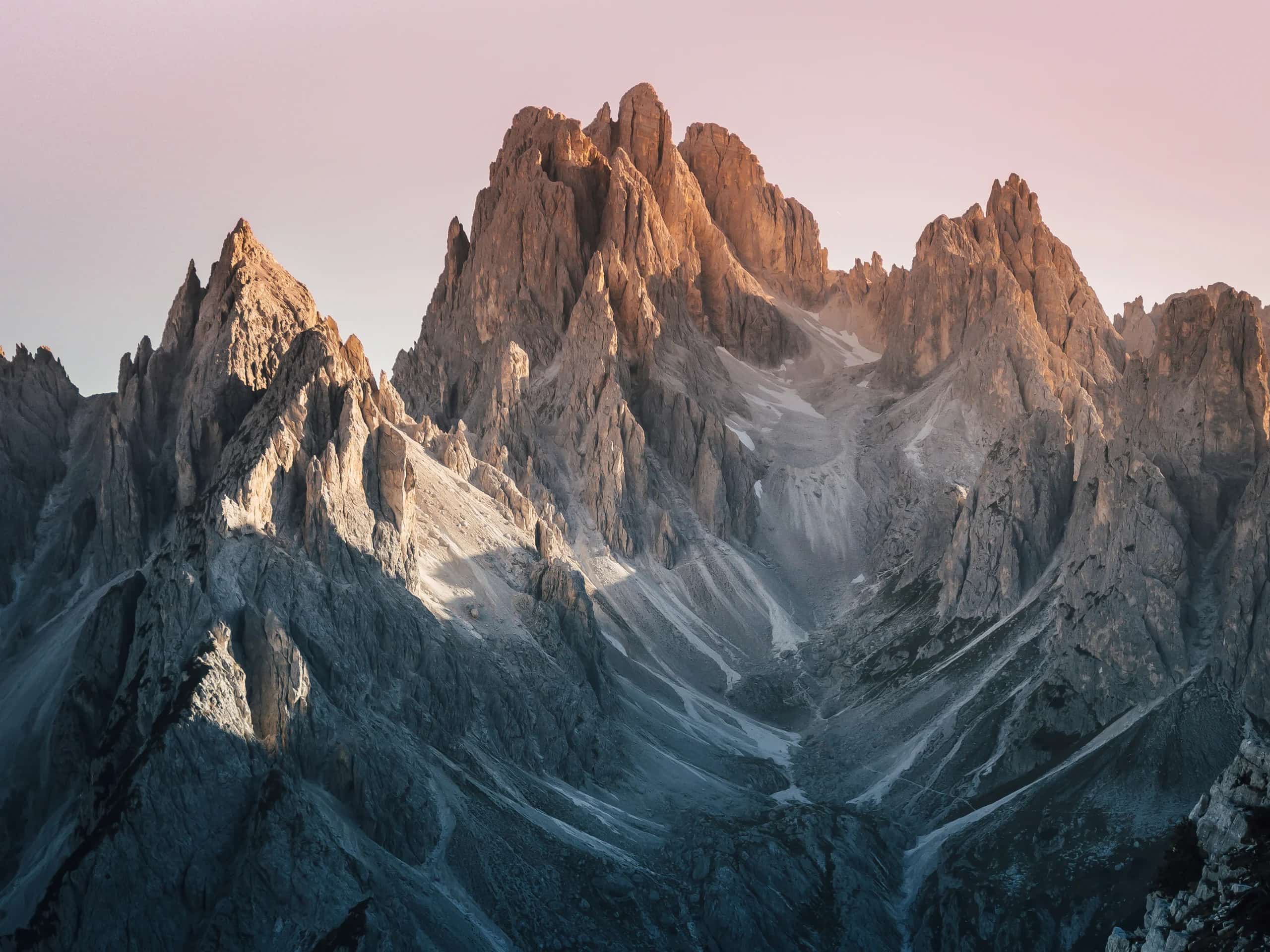 Alpenglow on the jagged spires of the Dolomites at dawn